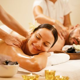 young-couple-enjoying-back-massage-health-spa-focus-is-smiling-woman-less